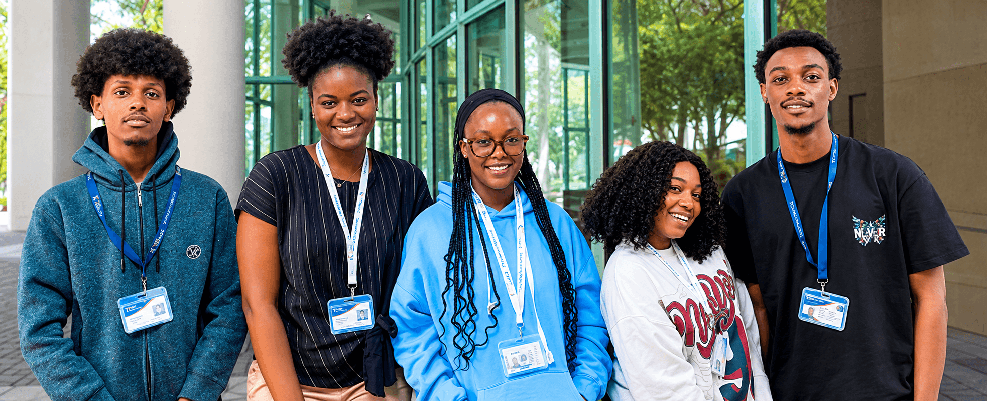 Cape View College students smiling in front of the campus